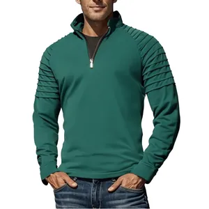 Close-up view of men's teal quarter-zip pullover featuring pleated shoulder details