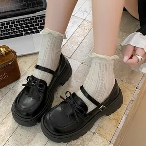 Stylish black platform Mary Jane shoes featuring a cute bow detail and elegant lace socks