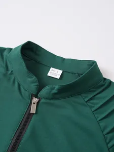Close-up detail of green men's sports sweatshirt collar with zipper and size tag