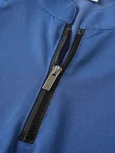 Close-up of high-quality silver metal zipper on a blue stand-up collar sports sweatshirt