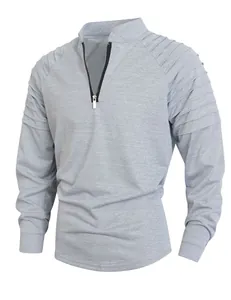 Detail view of men's grey long sleeve sports shirt with pleated shoulder and quarter zip