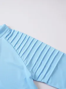 Detailed macro view showing the pleated texture on a blue men's sports sweatshirt.