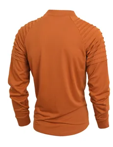 Back view of burnt orange men's fitness shirt with pleated shoulder details