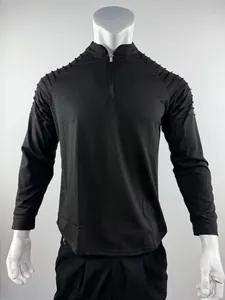 Detailed close-up view of men's black half-zip sports fitness shirt with shoulder pleats