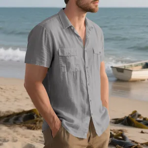 Dettaglio di una camicia grigia in lino da uomo con doppie tasche sul petto in spiaggia.