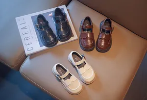 Detail view of girls' British style leather shoes in black, brown, and white colors.