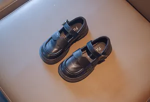 Close-up detail of black girls' British style Mary Jane shoes with scalloped edges