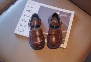 Vintage brown girls' Mary Jane leather shoes presented on a stylish lifestyle magazine