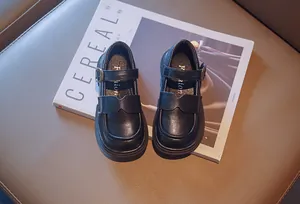 Detailed top view of black leather girls' Mary Jane shoes with buckle strap