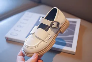 Detail of white girls' Mary Jane leather shoes with buckle and thick durable sole