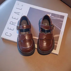 Girls' British style brown leather Mary Jane shoes presented on a minimalist background