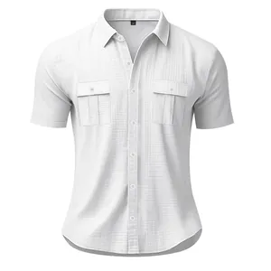 Detail view of a white linen-textured men's short-sleeve shirt with double chest pockets.