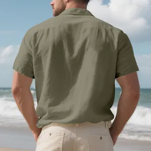 Rear view of a man wearing a casual olive green linen short sleeve shirt on the beach