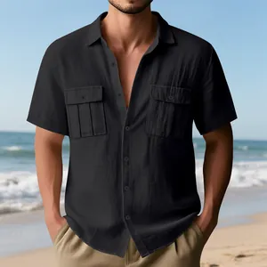 Men's black linen short sleeve cargo shirt with double pockets on beach.