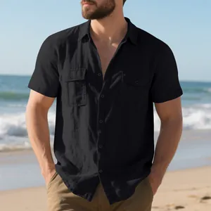 Detail view of a black men's linen beach shirt showing chest pockets and fabric texture