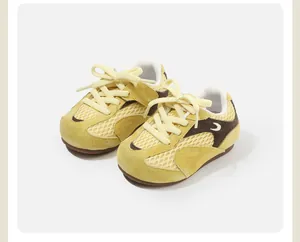 Close-up of yellow breathable mesh children's sneakers with lace-up design