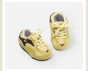 Close-up of breathable yellow mesh toddler sneakers with soft suede details