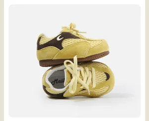 Macro detail of yellow and brown toddler sneakers with breathable mesh and suede.