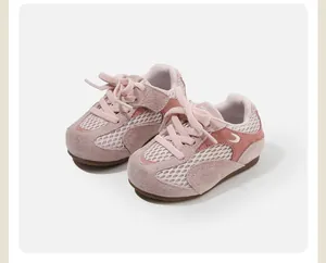 Close-up view of pink mesh and suede toddler walking shoes with a secure lace-up design