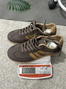 Lightweight women's brown GAT sneakers weight measurement shown on a digital scale
