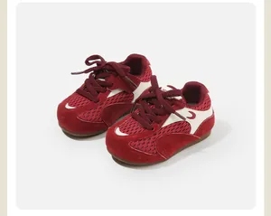 Detailed view of red toddler sneakers featuring breathable mesh and soft suede panels.