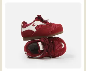 Close-up view of red breathable mesh toddler sneakers with durable rubber soles
