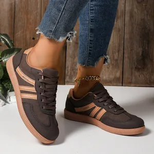 Detailed side view of brown women's casual T-toe sneakers with non-slip gum soles.