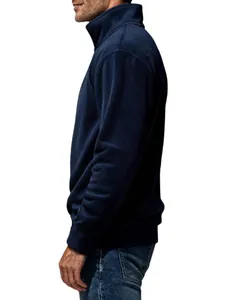 Side profile of a man wearing a classic navy blue quarter-zip fleece sweatshirt