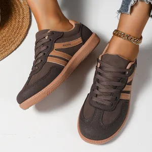 Detailed close-up view of brown German Army Trainer sneakers worn with a gold anklet.