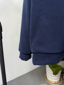 Macro view of the navy blue polar fleece sweatshirt hem and cuff texture detail