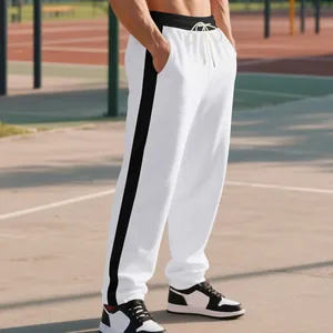 Men's white loose-fit casual sweatpants with contrast black side stripes on athletic track