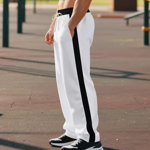 Side view of men's white heavy cotton sweatpants with black side stripes and loose straight fit.