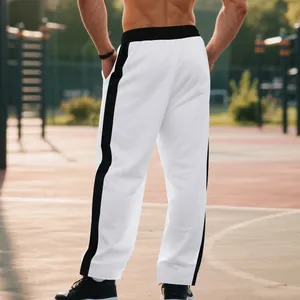 Back view of men's white baggy sweatpants with black side stripes in outdoor court
