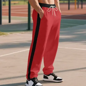 Men's heavy red sweatpants with black side stripes and white drawstring cords