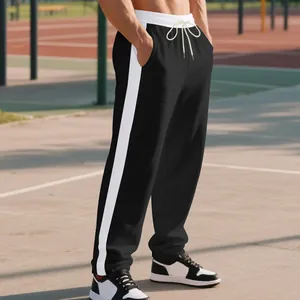 Detailed view of men's heavy fleece loose sweatpants with white contrast side stripes.