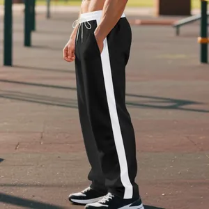 Side view of men's wide-leg sweatpants with a bold white stripe design