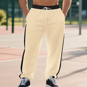 Close-up of men's heavy fleece joggers featuring stylish black side stripes and drawcord