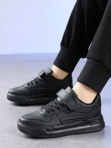 Chaussures de sport noires pour garçons avec velcro pour l'école et les loisirs.