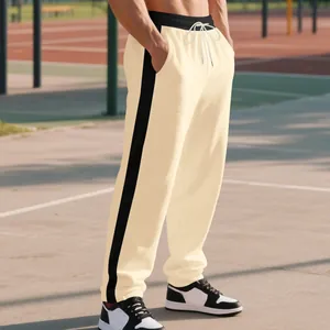 Detail view of men's heavy cream sweatpants with a side black stripe and drawstring