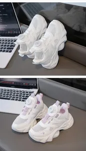 Close-up view of children's breathable white mesh sneakers with convenient rotary buckle