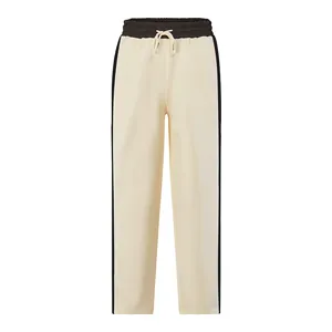 Close-up detail of men's heavyweight french terry color-block sweatpants in cream and black