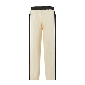 Back view of cream men's loose heavy cotton sweatpants with black side stripes