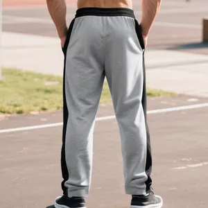 Back view of men's heavy-weight grey joggers with black side stripes outdoor