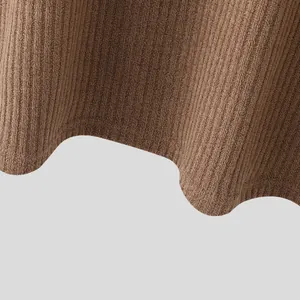 Detailed close-up view of brown ribbed knit fabric texture and soft garment hemline.