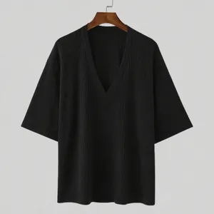 Detail of black ribbed knit T-shirt with deep V-neck and mid-length sleeves