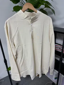 Detail view of men's long sleeve mandarin collar shirt in light yellow stripe