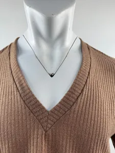 Close-up detail of a brown V-neck ribbed knit sweater showcased on a white mannequin