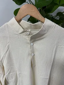 Close-up of the stand-up collar and seersucker striped texture on this casual men's shirt.