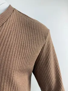 Detail view showing the fine brown ribbed knit texture of an elastic summer T-shirt
