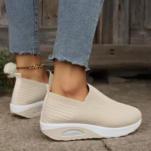 Detailed view of breathable beige fly-knit slip-on rocker shoes with air cushion sole